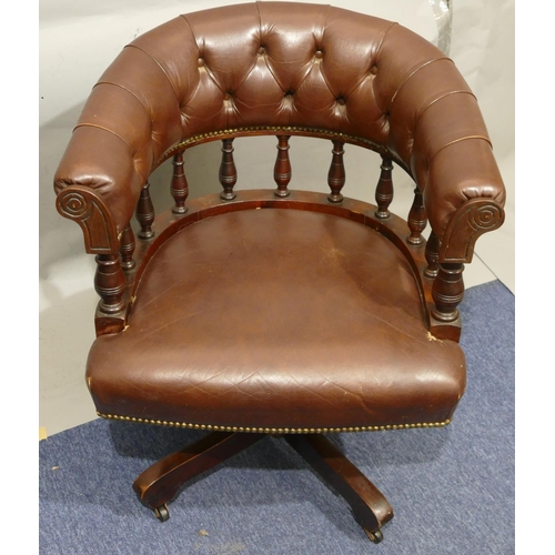 870 - A Hillcrest mahogany and dark brown leather tub swivel desk chair with part turned spindle back, X-s... 