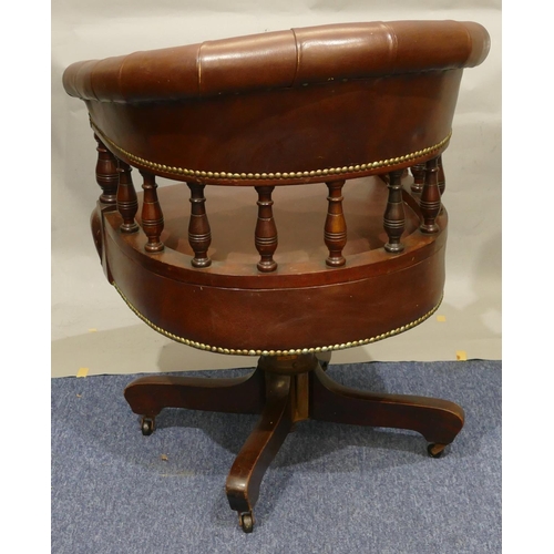 870 - A Hillcrest mahogany and dark brown leather tub swivel desk chair with part turned spindle back, X-s... 