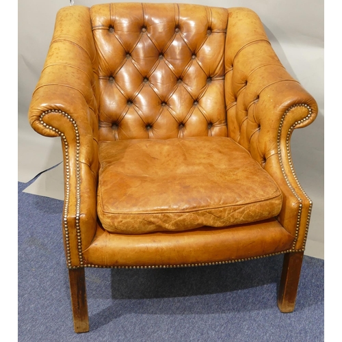 873 - A mahogany framed and brown leather armchair with buttoned back, sides and studded decoration, leath... 