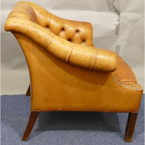 873 - A mahogany framed and brown leather armchair with buttoned back, sides and studded decoration, leath... 