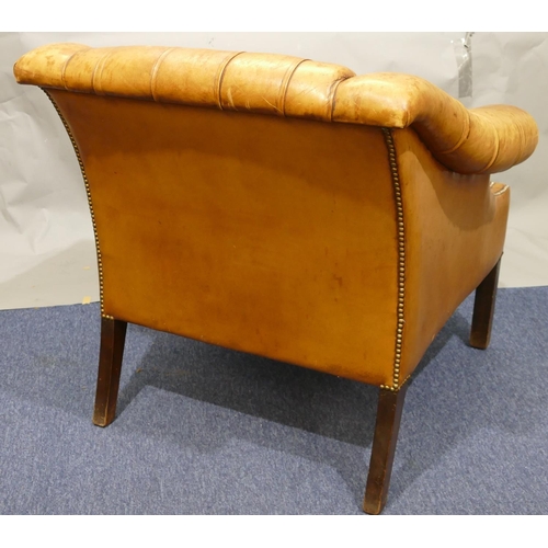 873 - A mahogany framed and brown leather armchair with buttoned back, sides and studded decoration, leath... 