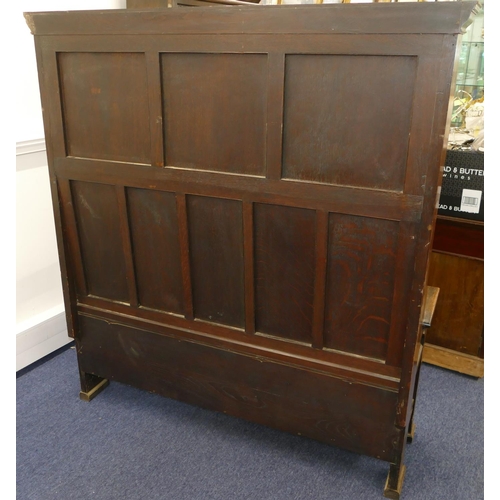 875 - An oak tall back settle with plain and carved panel back, hinged seat with further carved panels to ... 