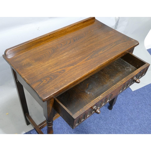 876 - An oak side table with lipped back, single drawer with thumb pattern decoration, on round turned leg... 