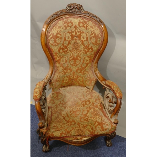 880 - A Victorian walnut spoon back armchair with allover pierced and raised carved floral, leaf and scrol... 