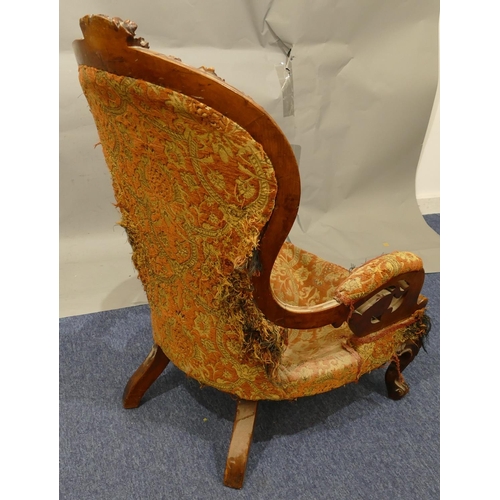 880 - A Victorian walnut spoon back armchair with allover pierced and raised carved floral, leaf and scrol... 