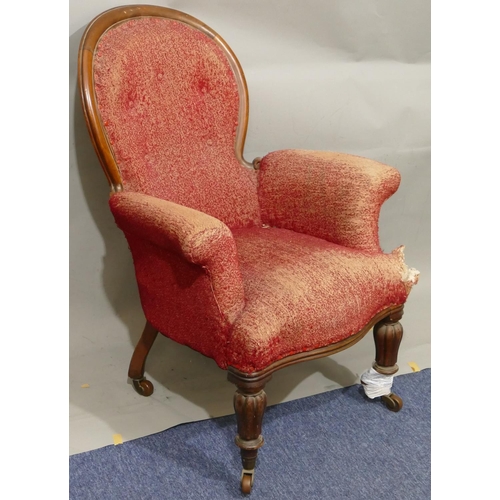 881 - A Victorian mahogany framed spoon back armchair with overstuffed seat, button back and padded arms (... 