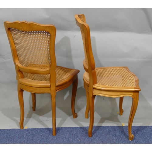 890 - A set of 12 Continental single chairs with Bergere backs and seats with carved scroll motifs, on cab... 