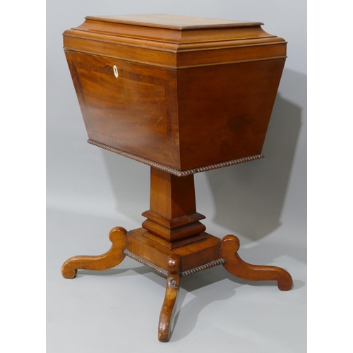 894 - A 19th Century sarcophagus shaped mahogany teapoy with banded hinged top, enclosing 2 lidded compart... 