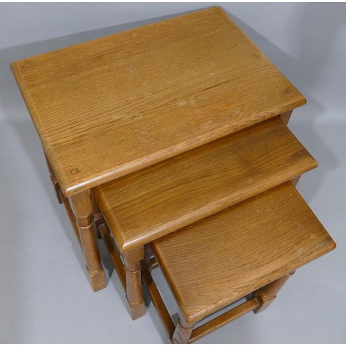 896 - A nest of 3 oak rectangular shaped coffee tables on round turned legs with stretchers, largest 48.5c... 