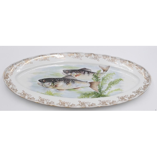 9 - A Limoges fish service on white and gilt ground with multi-coloured varying fish motifs, 1 oval serv... 