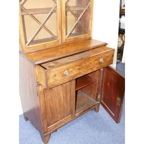 901 - A small George III mahogany bookcase with 2 astrical glazed doors above 1 long drawer, 2 panel doors... 