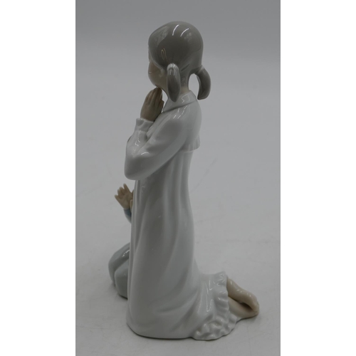 112 - A Lladro group of a kneeling young girl and boy praying, 22cm high.