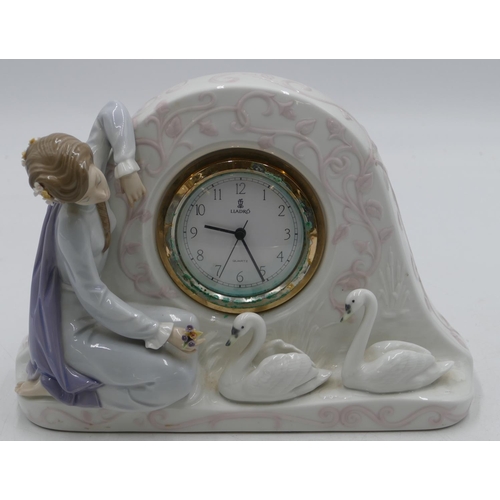 113 - A Lladro clock with raised figure of a seated young lady with 2 swans, Arabic numerals and seconds h... 