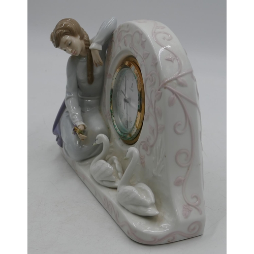 113 - A Lladro clock with raised figure of a seated young lady with 2 swans, Arabic numerals and seconds h... 