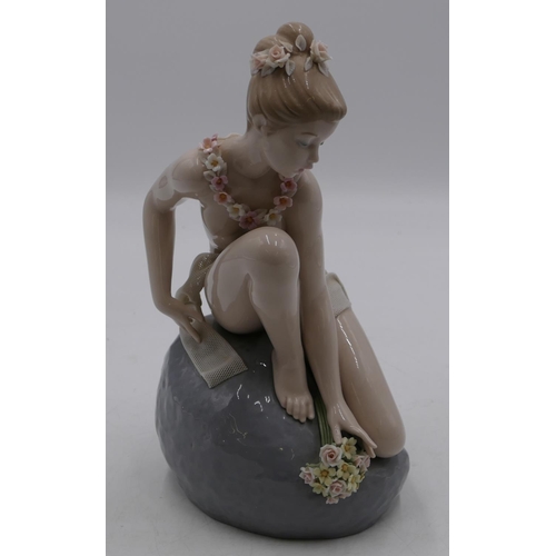 115 - A Lladro figure of a seated female nude on rock with allover encrusted floral decoration, 29.5cm hig... 