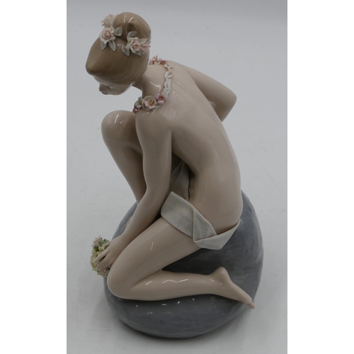 115 - A Lladro figure of a seated female nude on rock with allover encrusted floral decoration, 29.5cm hig... 