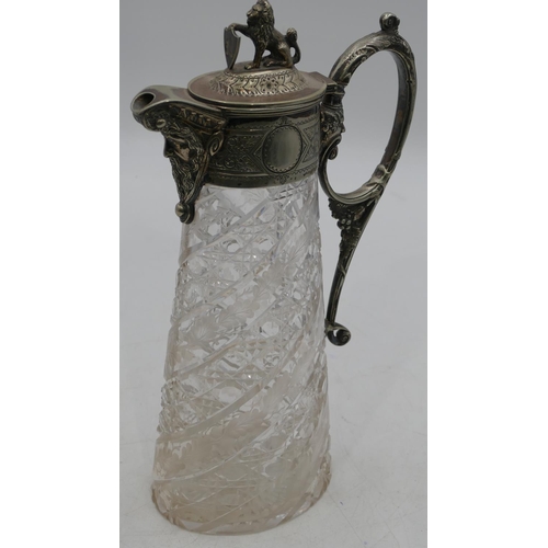 156 - A heavy oval cut glass claret jug with silver-plated neck, handle and hinged lid with mask head and ... 