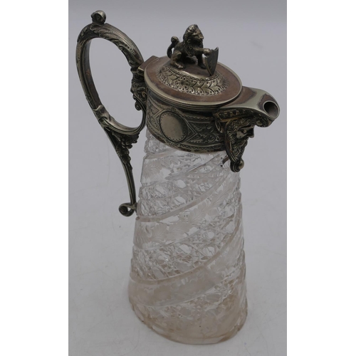 156 - A heavy oval cut glass claret jug with silver-plated neck, handle and hinged lid with mask head and ... 