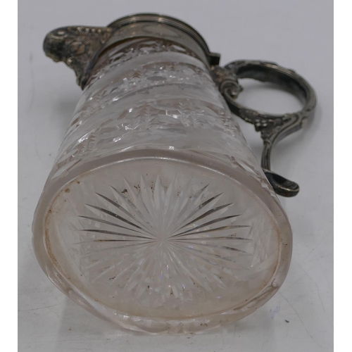 156 - A heavy oval cut glass claret jug with silver-plated neck, handle and hinged lid with mask head and ... 