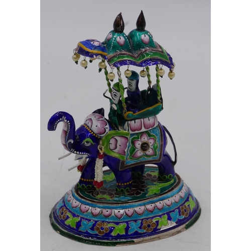 158 - An Indian silver-coloured metal and enamel group of figures riding an elephant on multi-coloured gro... 