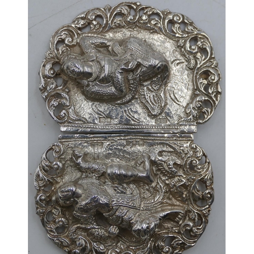 181 - An Eastern silver-coloured metal buckle with embossed and pierced figure and scroll decoration, 9.4c... 