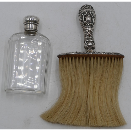 183 - A Birmingham silver handled crumb brush with embossed decoration and a cut glass dressing table bott... 