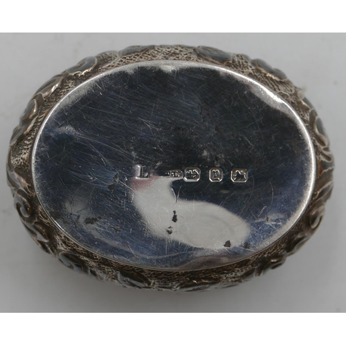 186 - A Birmingham silver oval bulbous shaped pill box with hinged lid, allover embossed floral, leaf and ... 