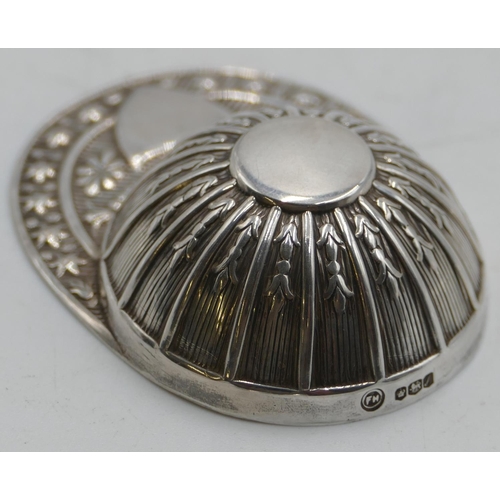 193 - A modern Sheffield silver caddy spoon in form of a cap with embossed decoration.