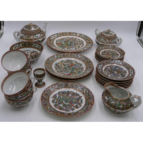 2 - A 20th Century Chinese eggshell tea service on white ground with multi coloured butterfly decoration... 