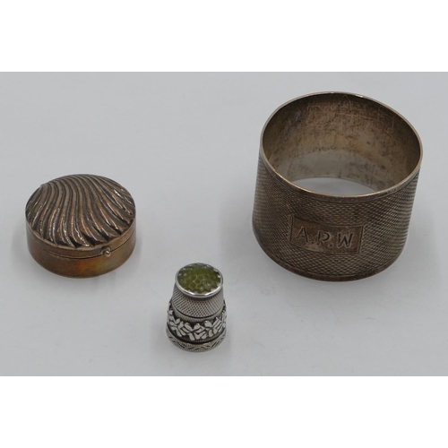 205 - A Sheffield silver round napkin ring with engine turn decoration, a 925 silver round pill box with e... 