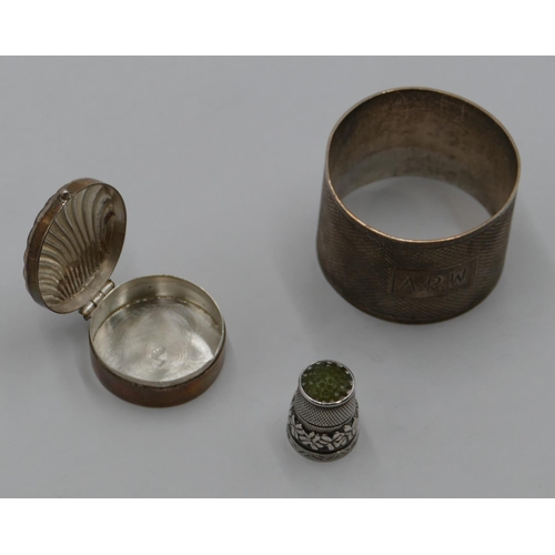 205 - A Sheffield silver round napkin ring with engine turn decoration, a 925 silver round pill box with e... 