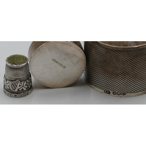 205 - A Sheffield silver round napkin ring with engine turn decoration, a 925 silver round pill box with e... 