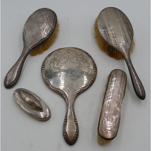 208 - A Birmingham silver hand mirror and matching hair brush with engraved ribbon, swag and scroll decora... 