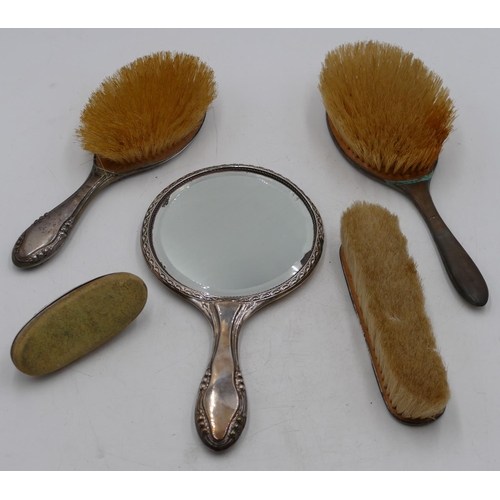 208 - A Birmingham silver hand mirror and matching hair brush with engraved ribbon, swag and scroll decora... 