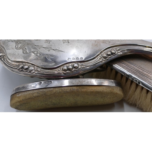 208 - A Birmingham silver hand mirror and matching hair brush with engraved ribbon, swag and scroll decora... 