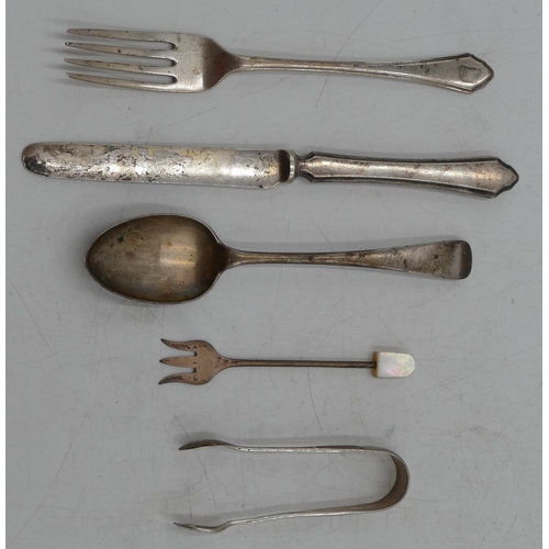 212 - A George V child's knife and fork, Sheffield 1934, maker Mappin and Webb, a London silver tea spoon,... 