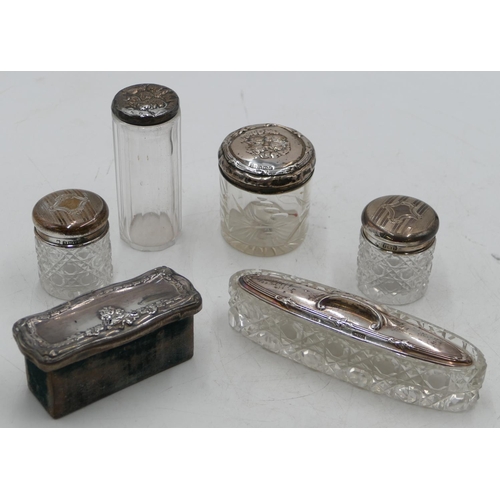 213 - An oblong cut glass dressing table bottle with Chester silver lid, 16.5cm long, 4 other glass dressi... 