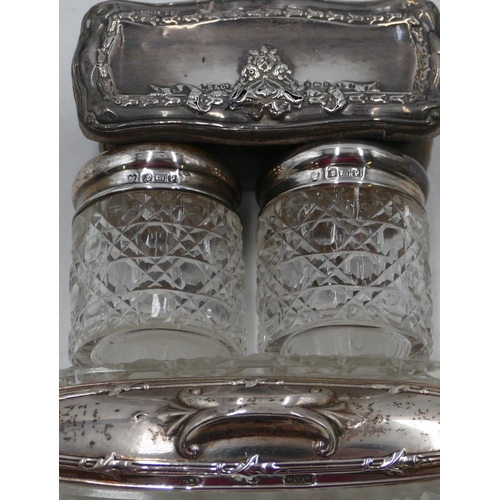 213 - An oblong cut glass dressing table bottle with Chester silver lid, 16.5cm long, 4 other glass dressi... 