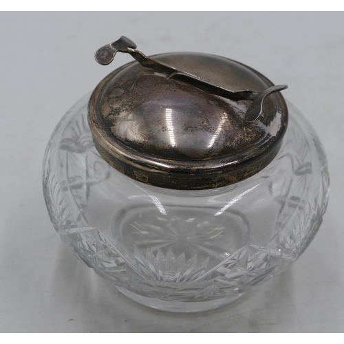 219 - A cut glass round bulbous shaped sugar bowl with Birmingham silver top and mounted with mechanical t... 