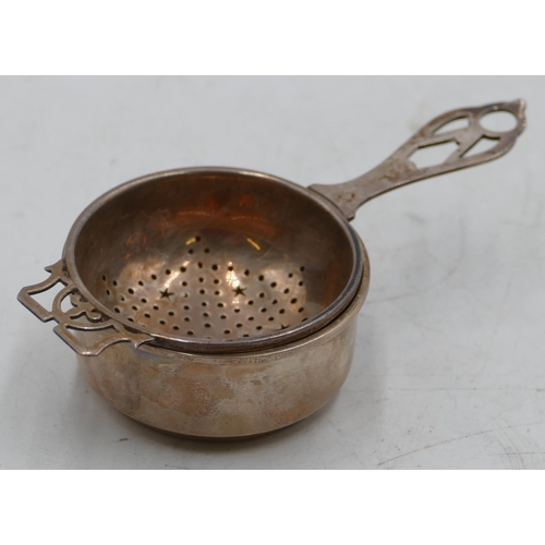 221 - A Birmingham silver tea strainer with stand with pierced handle, 1.8oz.