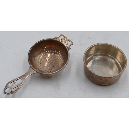 221 - A Birmingham silver tea strainer with stand with pierced handle, 1.8oz.