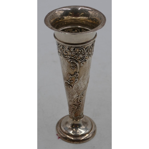 228 - An Edward VII silver trumpet shaped spill vase with allover embossed floral and scroll decoration, o... 