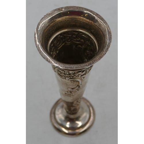 228 - An Edward VII silver trumpet shaped spill vase with allover embossed floral and scroll decoration, o... 