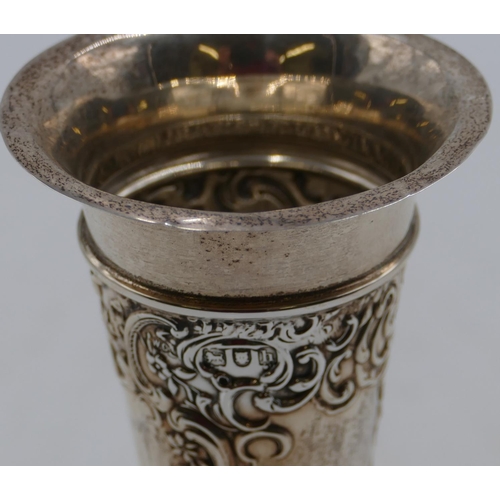 228 - An Edward VII silver trumpet shaped spill vase with allover embossed floral and scroll decoration, o... 