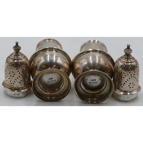 229 - A pair of Edward VII silver round bulbous shaped pepper pots, Birmingham 1902, makers mark A & L Ltd... 