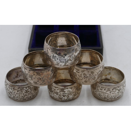 231 - A set of 6 Edward VII silver round bulbous shaped napkin rings with allover chased, floral and scrol... 