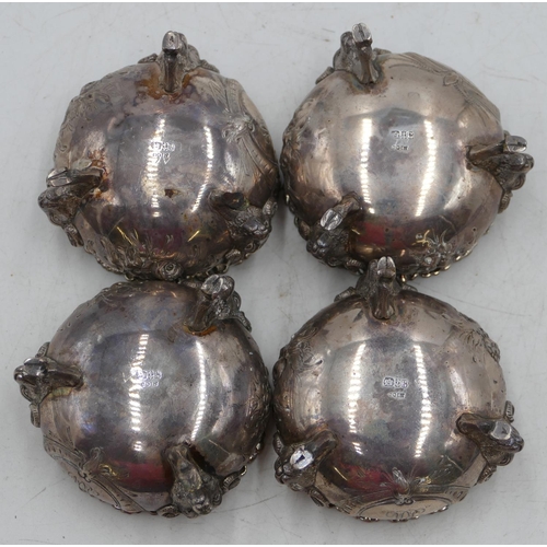 232 - A set of 4 George V silver round bulbous shaped salts with crinkled rims, embossed floral and leaf d... 