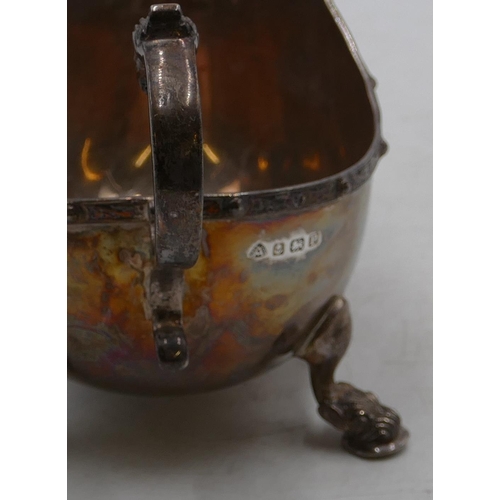 234 - A Birmingham silver sauce boat with scroll handle with animal motif on splayed feet, maker ADI Bros ... 