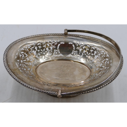 236 - A Sheffield silver oval cake basket with swing overhead handle, allover pierced leaf and scroll deco... 