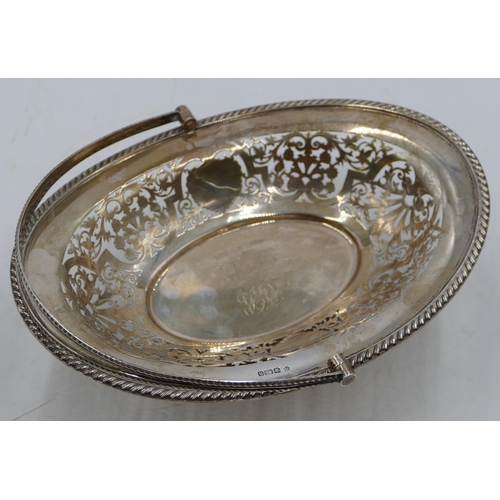 236 - A Sheffield silver oval cake basket with swing overhead handle, allover pierced leaf and scroll deco... 